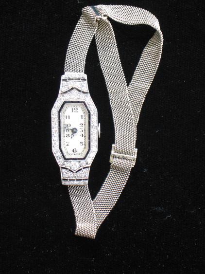 Appraisal: AN EDWARDIAN LADY'S DIAMOND COCKTAIL WATCH the white rectangular dial