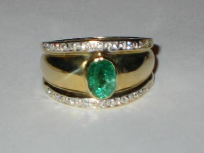 Appraisal: AN EMERALD AND DIAMOND RING the thick ct gold band