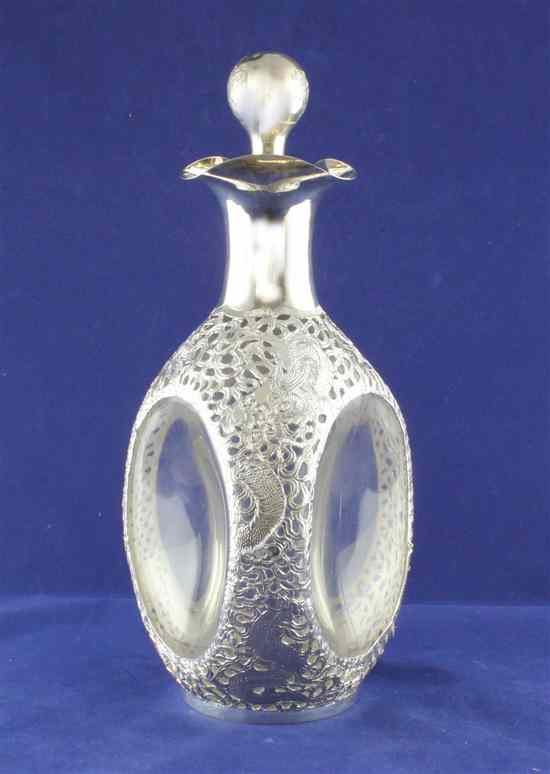 Appraisal: A Japanese pierced white metal mounted glass triple-lipped decanter with