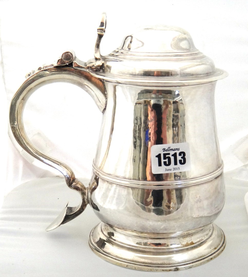 Appraisal: A George II silver hinge lidded tankard of baluster form