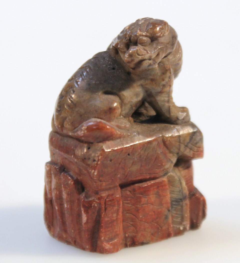 Appraisal: A Chinese soapstone seal in red and grey carved as