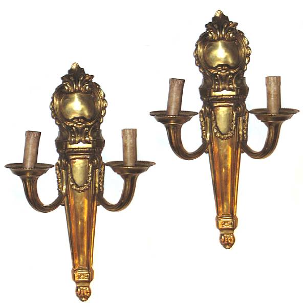 Appraisal: A pair of Neoclassical style two light gilt bronze sconces