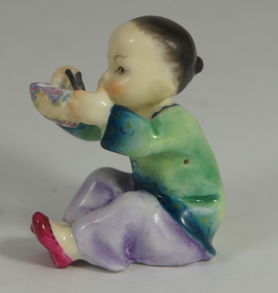 Appraisal: Royal Worcester figure of boy eating Rice ''China'' height cm