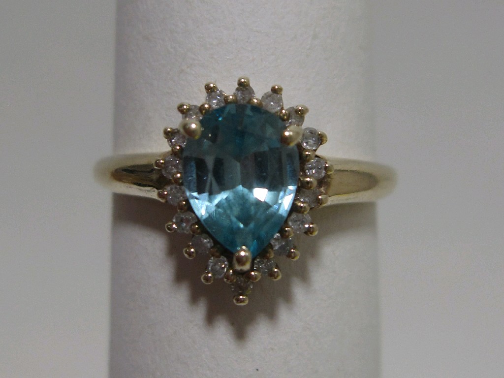 Appraisal: Nine carat gold blue topaz and diamond pear shaped cluster