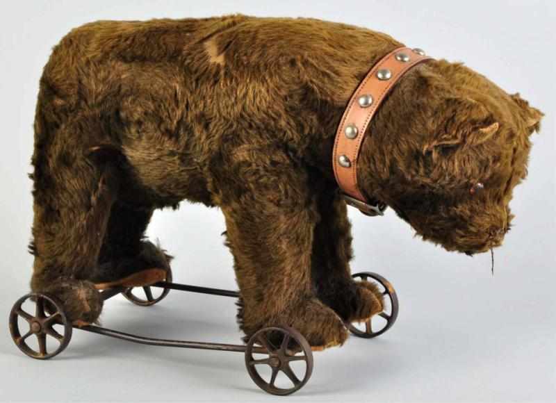 Appraisal: Large Fur-Covered Bear on Wheels Pull Toy Metal base and