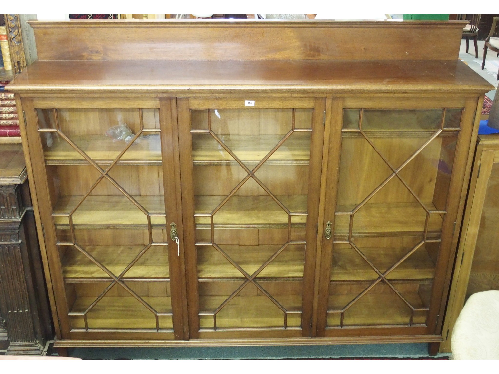 Appraisal: An Edwardian mahogany three door astragal glazed display cabinet x