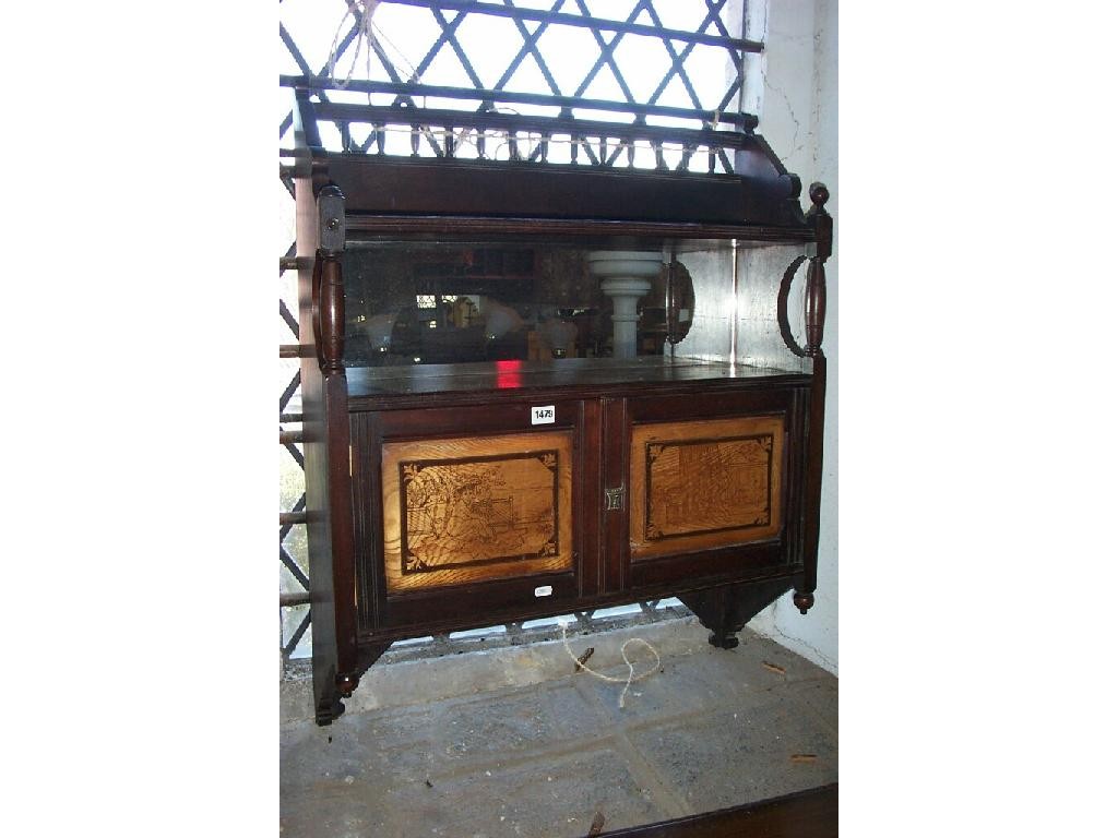 Appraisal: An Edwardian oak hanging shelf of stylised form with mirror