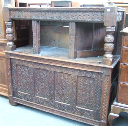 Appraisal: A carved oak cupboard late th century with angled open