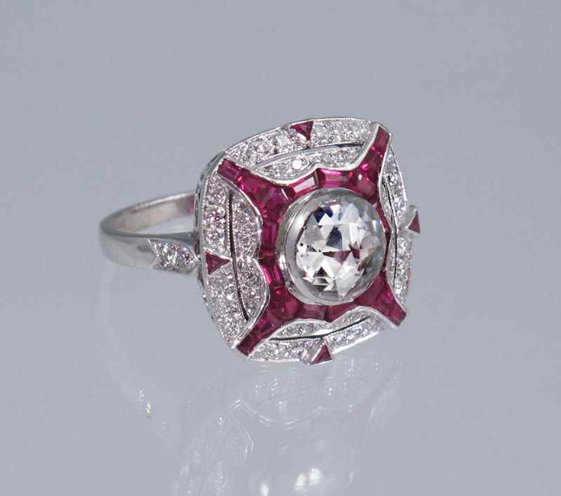 Appraisal: PLATINUM DIAMOND AND RUBY RING Platinum ring centers a round