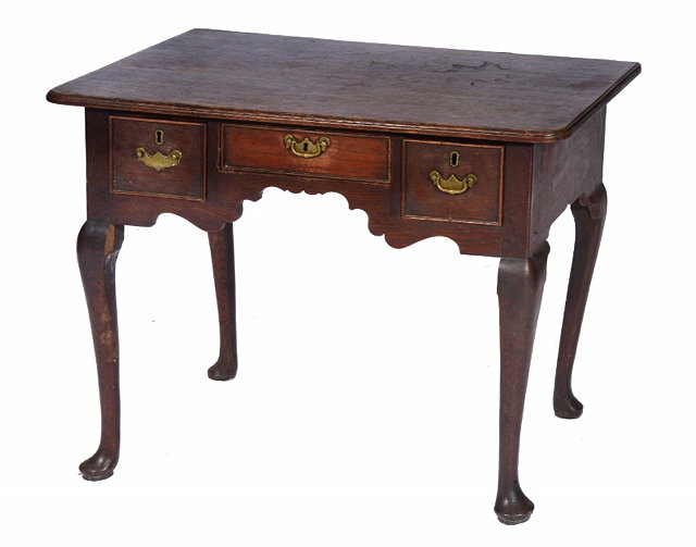 Appraisal: A GEORGE III OAK LOWBOY with three cockbeaded drawers with