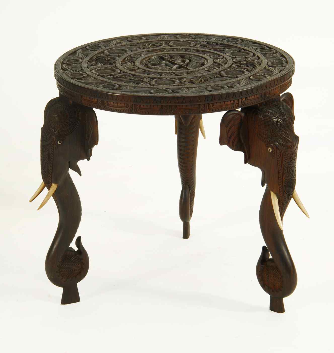 Appraisal: ANGLO-INDIAN ROUND CENTER TABLE WITH ELEPHANT HEAD-FORM LEGSCirca Finely carved