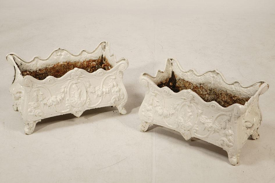 Appraisal: A PAIR OF VICTORIAN CAST IRON PLANTERS of scrolling rococo