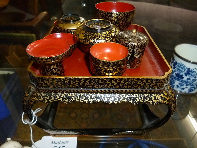 Appraisal: A JAPANESE LACQUERED STAND holding various model tea wares cm