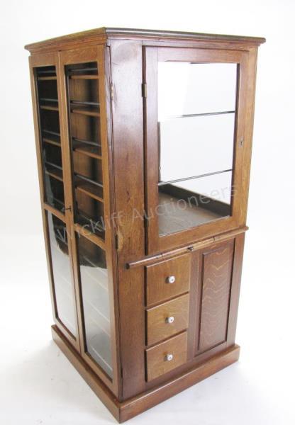 Appraisal: An antique golden oak dentist's cabinet mfd by B D