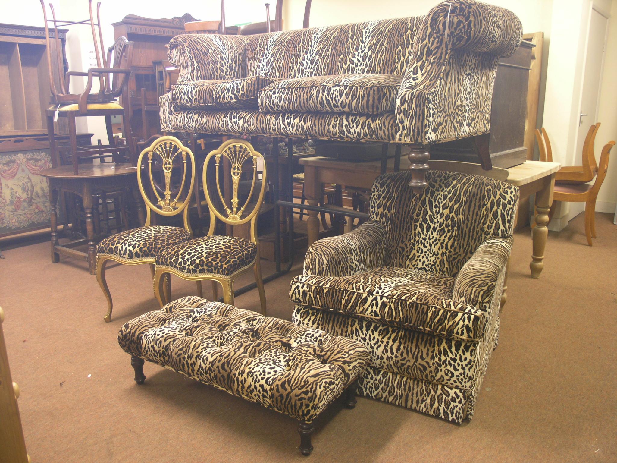 Appraisal: A Victorian-style settee covered in a leopard-skin effect fabric on