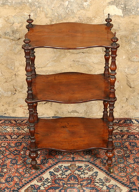 Appraisal: A VICTORIAN SERPENTINE ROSEWOOD THREE TIER WHATNOT with ring turned