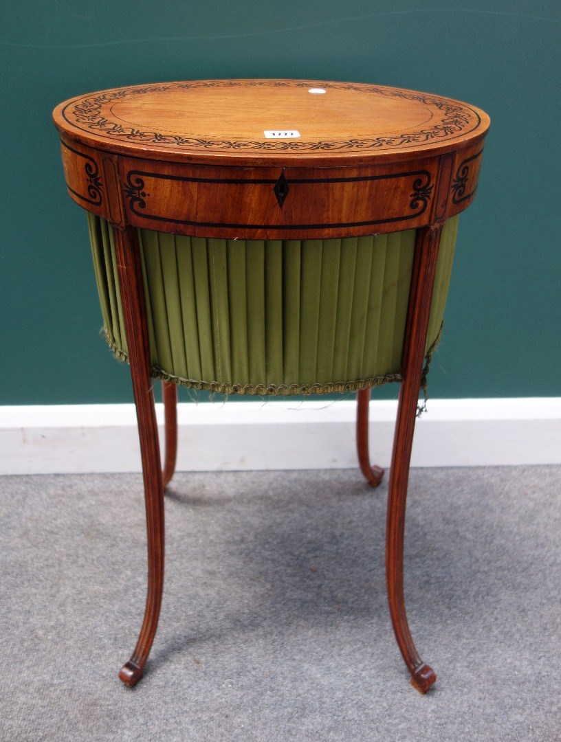 Appraisal: A Regency satinwood work table with inlaid oval lift top