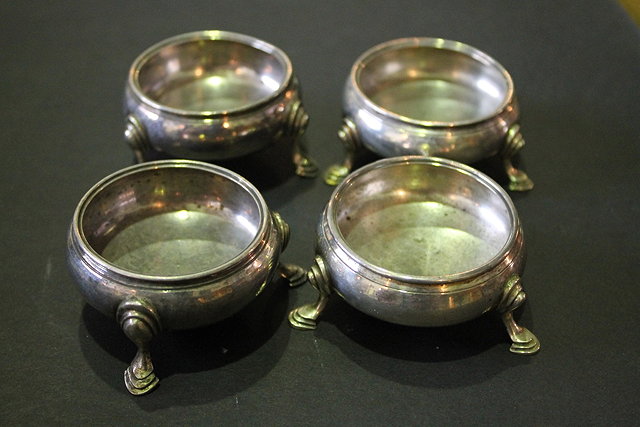 Appraisal: TWO PAIRS OF GEORGIAN SILVER SALTS of circular form on