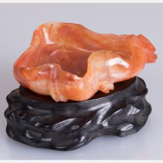 Appraisal: A Chinese Carved Agate Lotus Leaf Form Washer on a