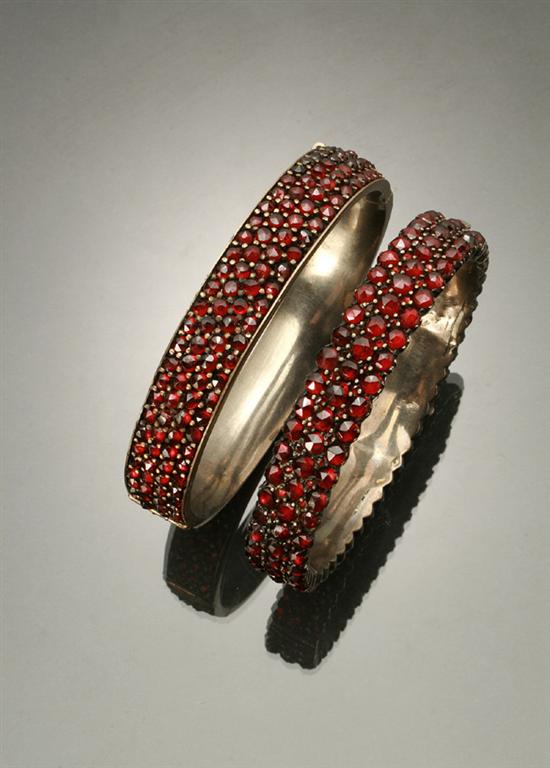 Appraisal: Pair of Victorian Base Metal and Garnet Bangle Bracelets Last