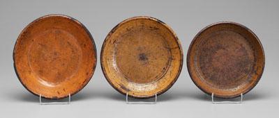 Appraisal: Three redware bowls one with orange yellow glaze back marked