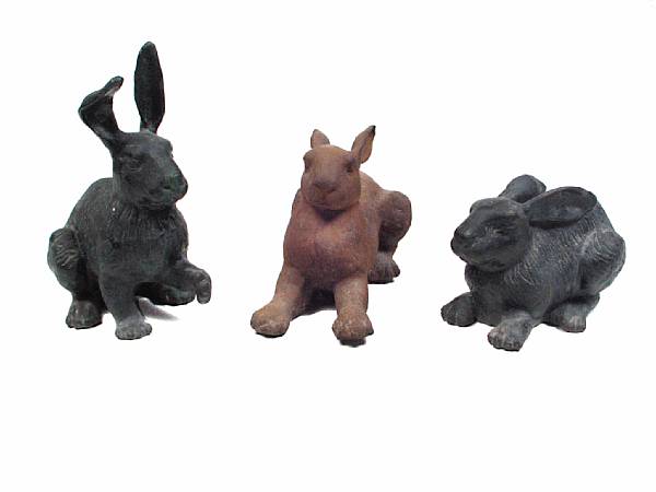 Appraisal: A group of three cast iron models of rabbits height