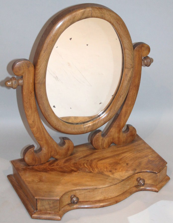 Appraisal: A Victorian mahogany table mirror the oval glass flanked by