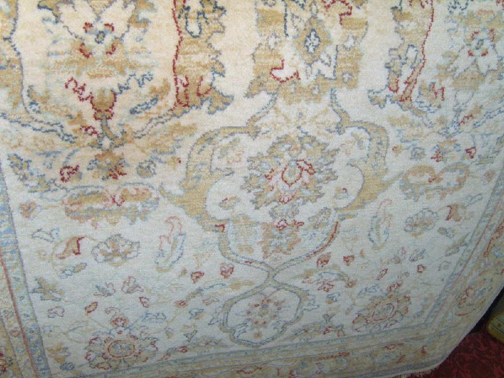 Appraisal: A cream ground wool rug in the Persian style with