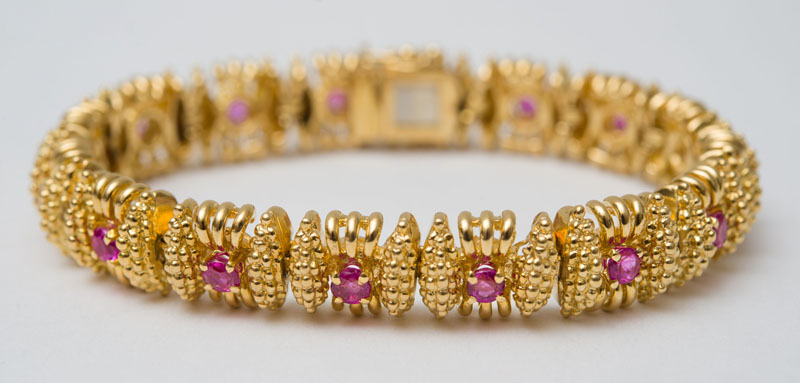 Appraisal: K GOLD AND RUBY BRACELET Set with round cut rubies