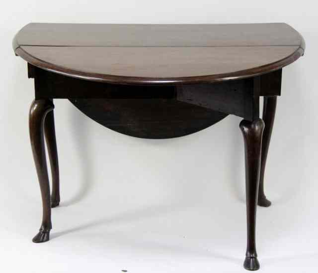 Appraisal: A George II mahogany oval drop-leaf table the later top