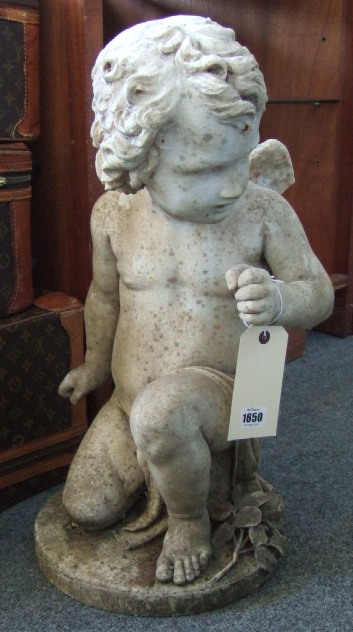 Appraisal: A carved marble figure of a kneeling Cupid th century