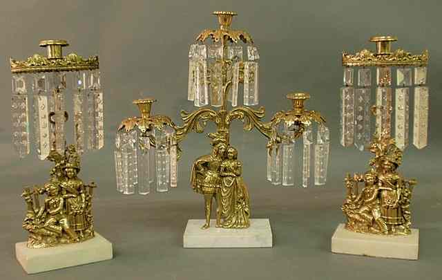 Appraisal: Three-piece brass girandole set late th c with figural groups