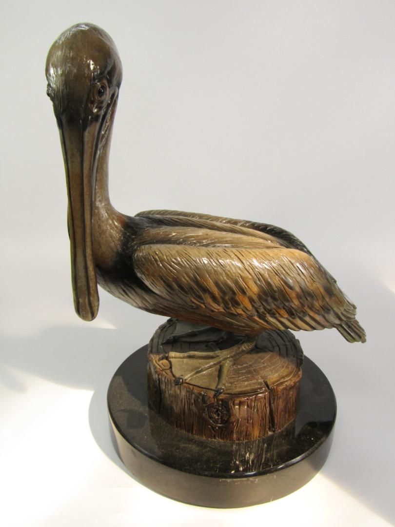 Appraisal: A pottery figure of a pelican perched on a tree