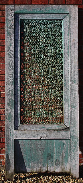 Appraisal: AN OLD OAK DOOR with green painted pierced cast iron