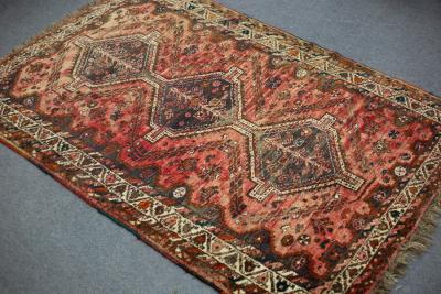 Appraisal: An Eastern rug the crimson ground with triple pole medallion