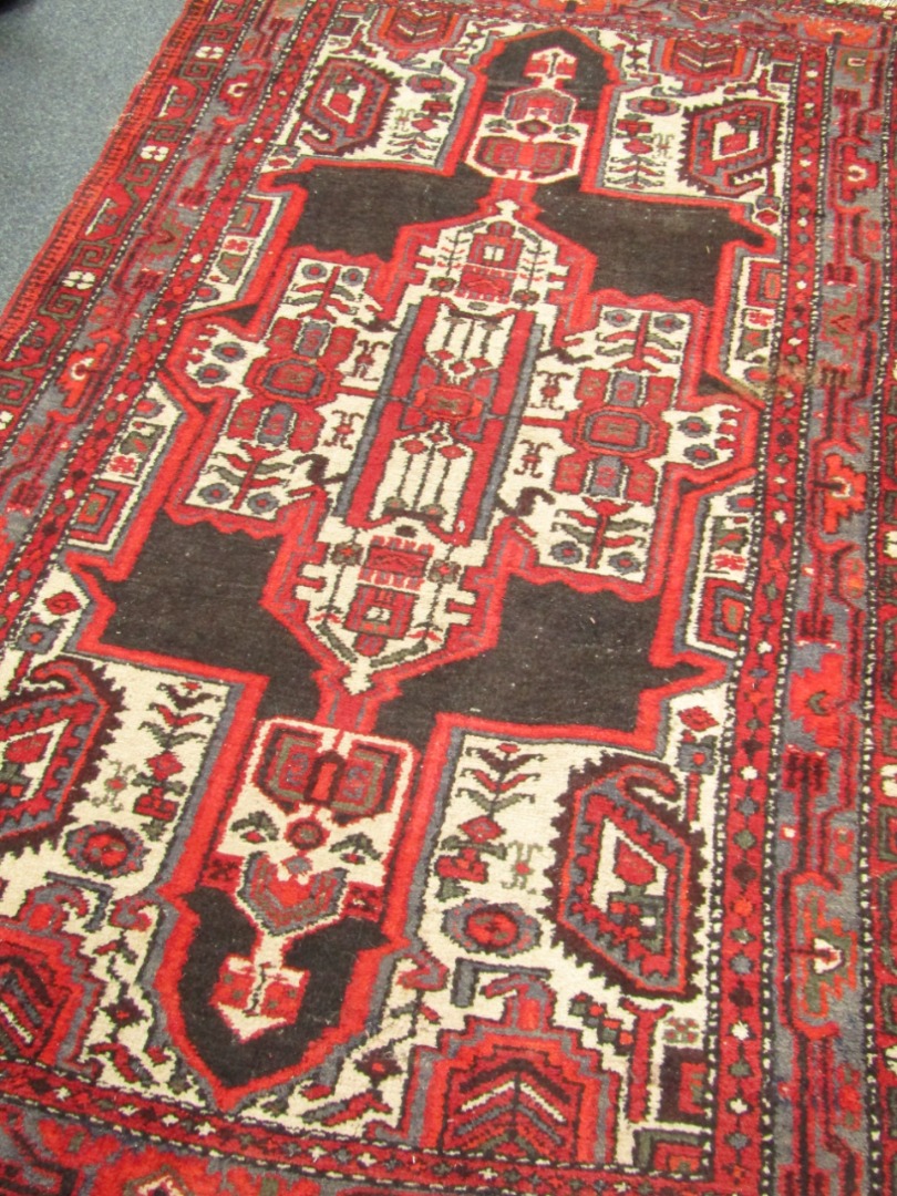 Appraisal: A Caucasian rug decorated with flowers botehs and geometric motifs