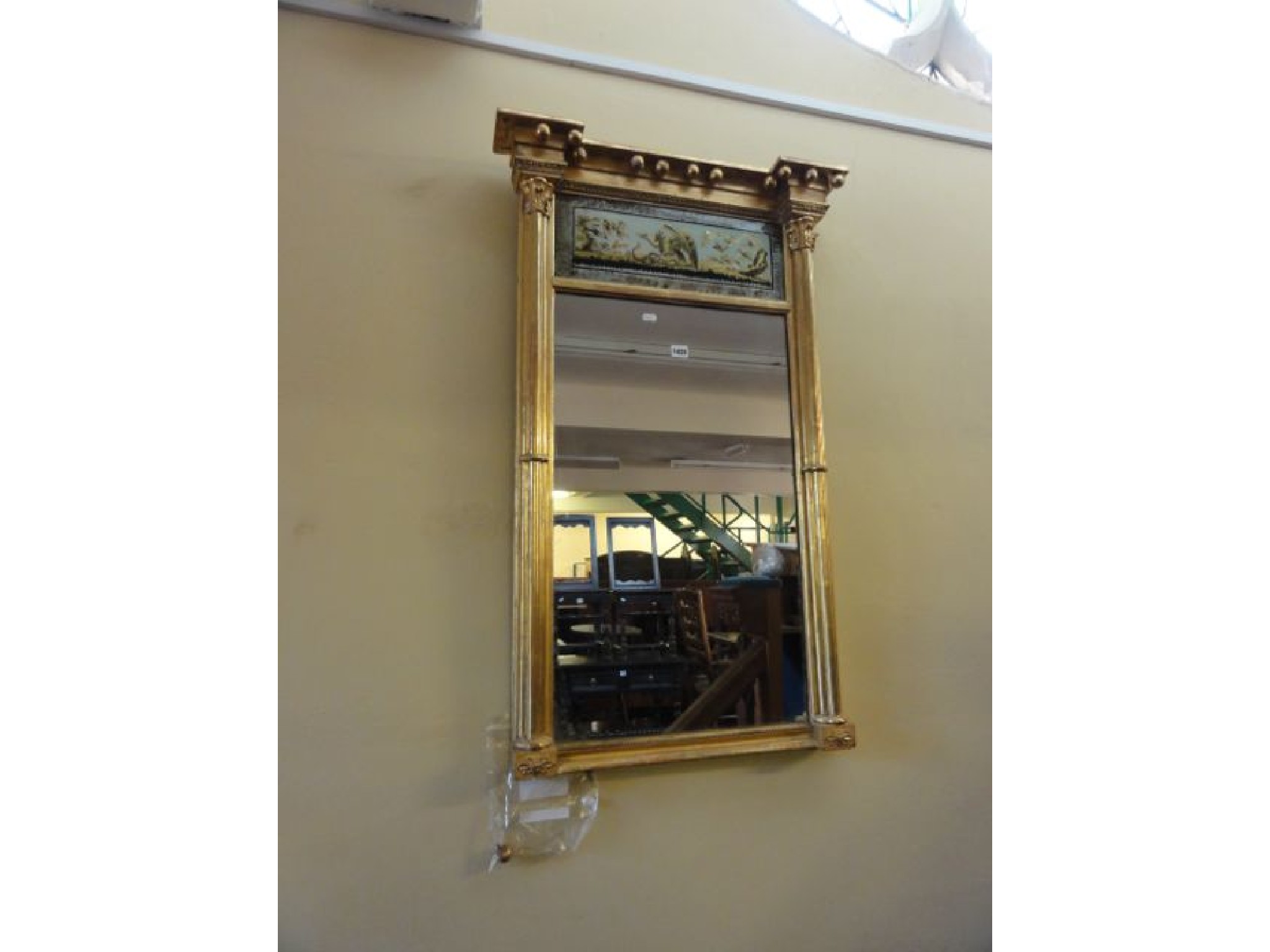 Appraisal: A Regency gilded pier glass with pilaster column supports the