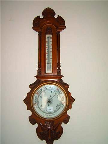 Appraisal: A late Victorian aneroid wall barometer and thermometer in a