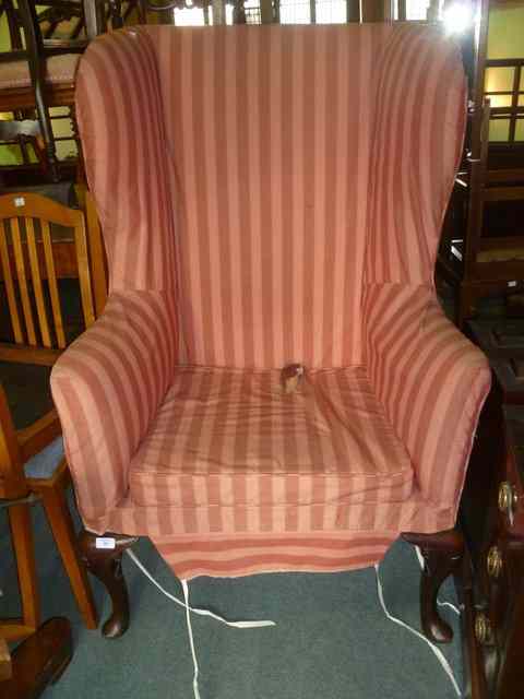 Appraisal: A GEORGE III WINGBACK ARMCHAIR on mahogany front cabriole supports