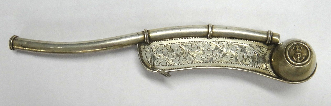 Appraisal: A silver boatswain's whistle with feathered scrolling engraved decoration and