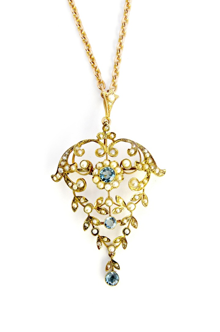 Appraisal: A gold aquamarine and seed pearl set pendant brooch in