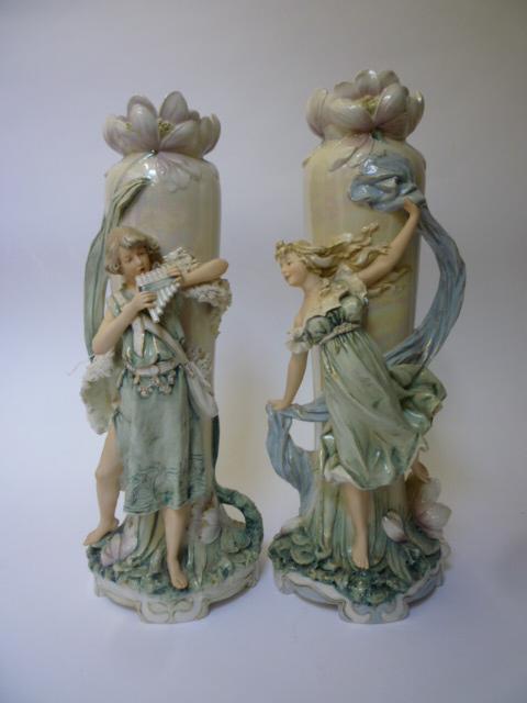 Appraisal: A PAIR OF ROYAL DUX PORCELAIN FIGURAL VASES modelled as