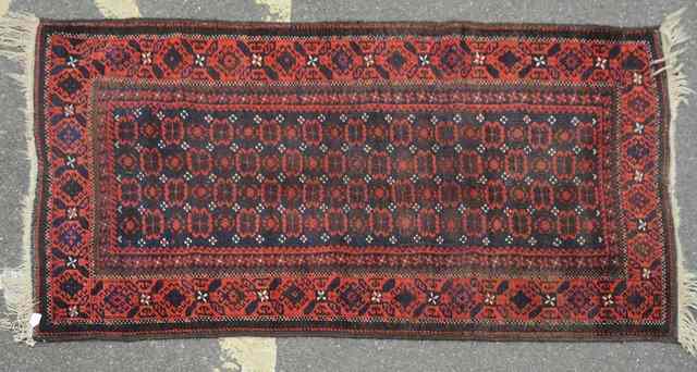 Appraisal: AN OLD BELOUCH RUG decorated four rows of palmettes within