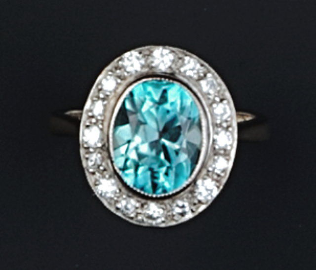 Appraisal: A ZIRCON AND DIAMOND CLUSTER RING the oval mixed-cut blue