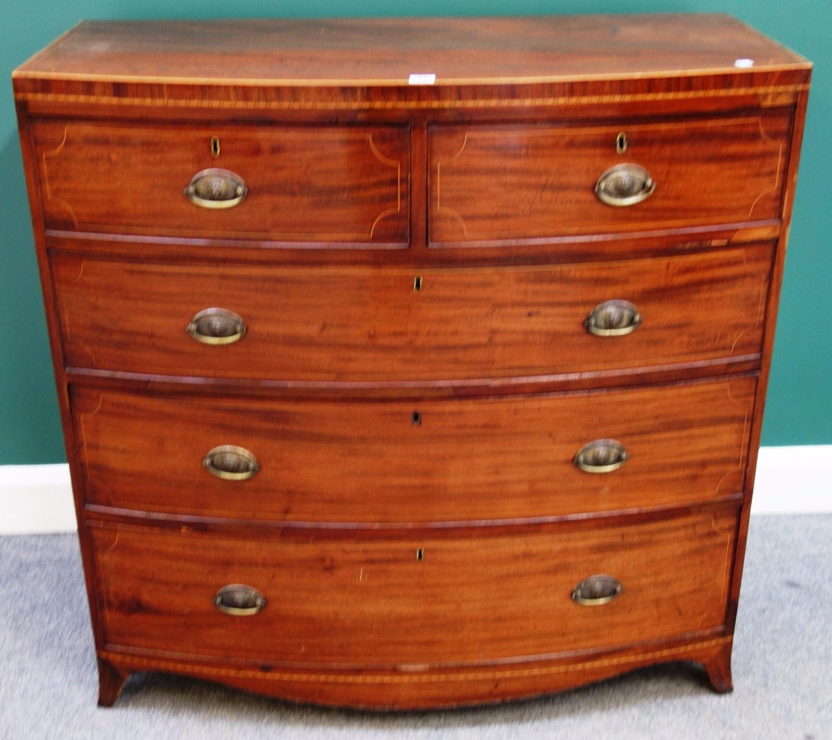 Appraisal: A Victorian inlaid mahogany bowfront chest of two short and