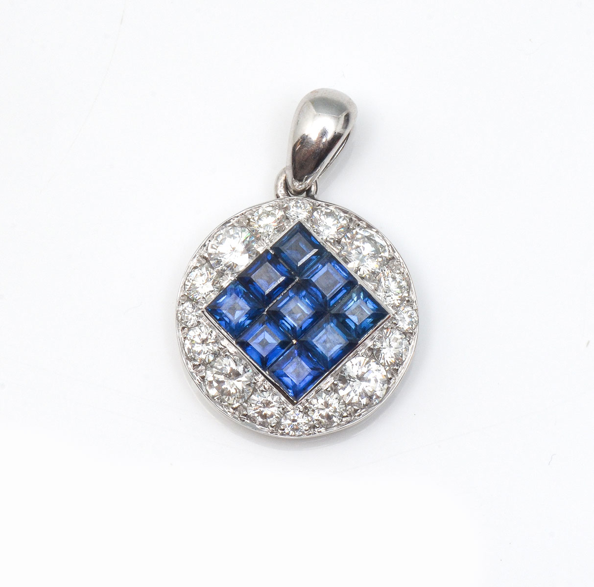 Appraisal: CHANNEL SET SAPPHIRE DIAMOND PENDANT square step cut sapphires are