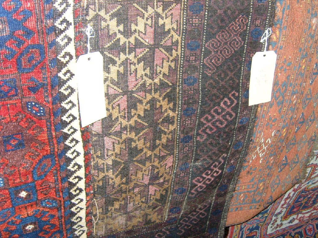 Appraisal: An Afghan saddleback face and two Persian rugs