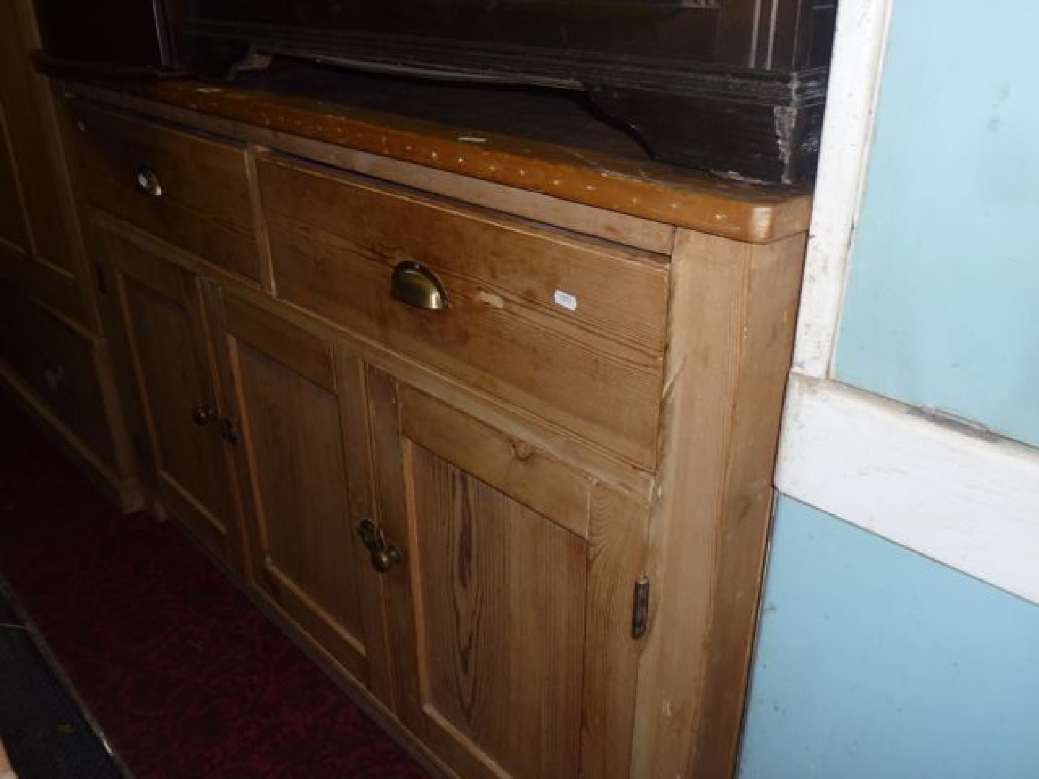 Appraisal: A vintage stripped pine dresser base partially enclosed by three