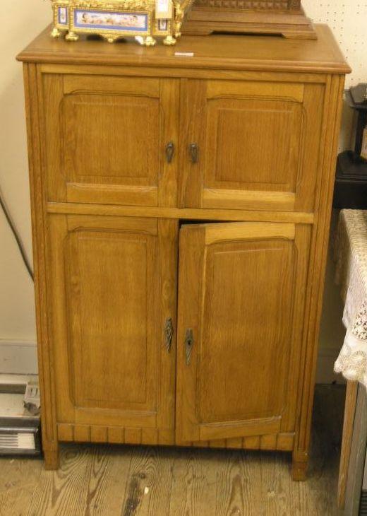 Appraisal: An solid light oak milinery cupboard enclosed by two pairs