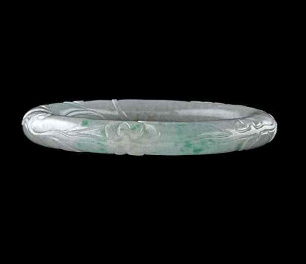 Appraisal: Green Jadeite Jade Carved Bangle Green jade bangle carved with